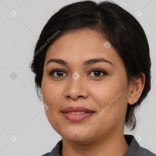 Joyful latino young-adult female with medium  brown hair and brown eyes