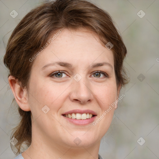 Joyful white adult female with medium  brown hair and green eyes