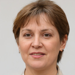 Joyful white adult female with medium  brown hair and grey eyes