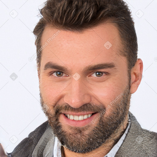 Joyful white adult male with short  brown hair and brown eyes