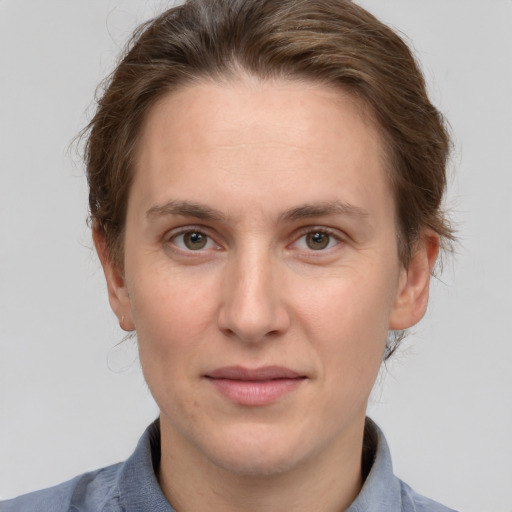 Joyful white adult female with short  brown hair and grey eyes