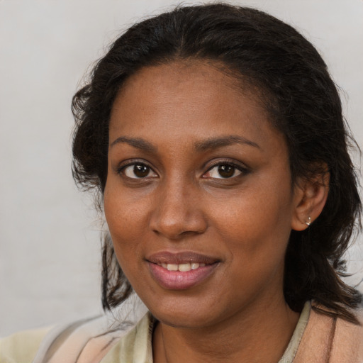 Joyful black young-adult female with medium  brown hair and brown eyes