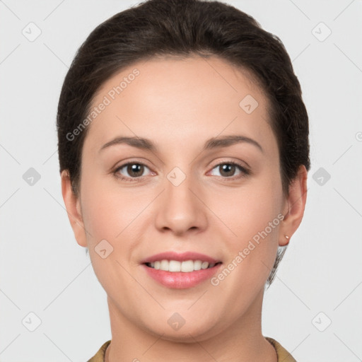 Joyful white young-adult female with short  brown hair and brown eyes