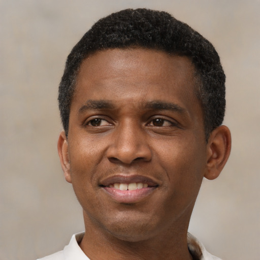 Joyful latino adult male with short  black hair and brown eyes