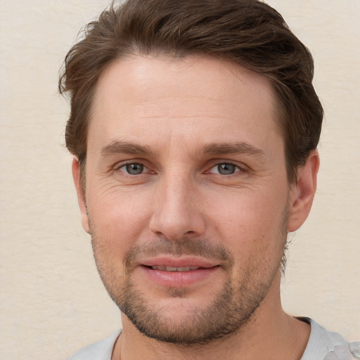 Joyful white young-adult male with short  brown hair and brown eyes