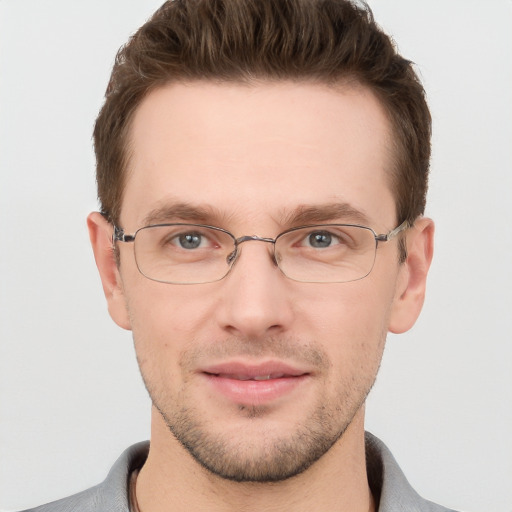 Joyful white adult male with short  brown hair and grey eyes