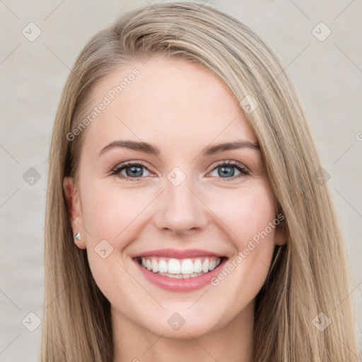 Joyful white young-adult female with long  brown hair and blue eyes