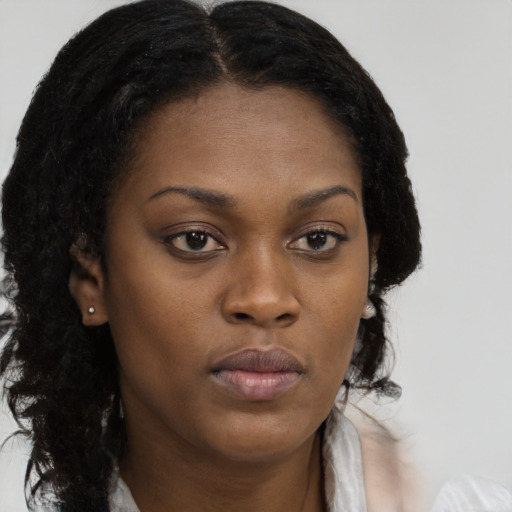 Neutral black young-adult female with long  brown hair and brown eyes