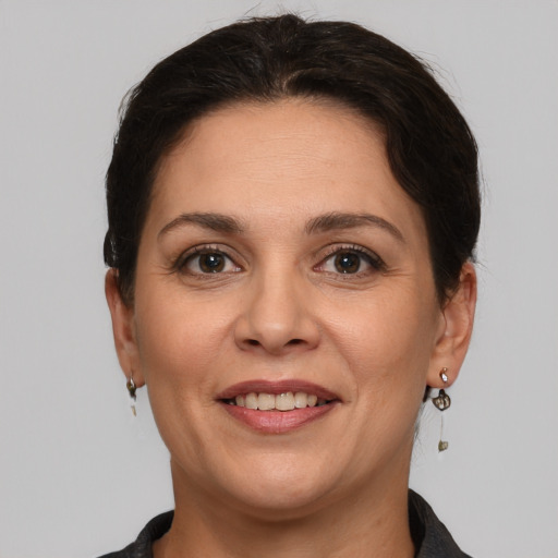 Joyful white adult female with short  brown hair and brown eyes