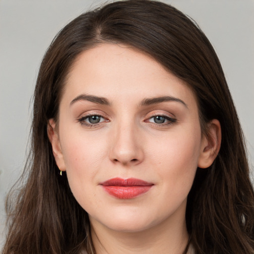 Joyful white young-adult female with long  brown hair and grey eyes