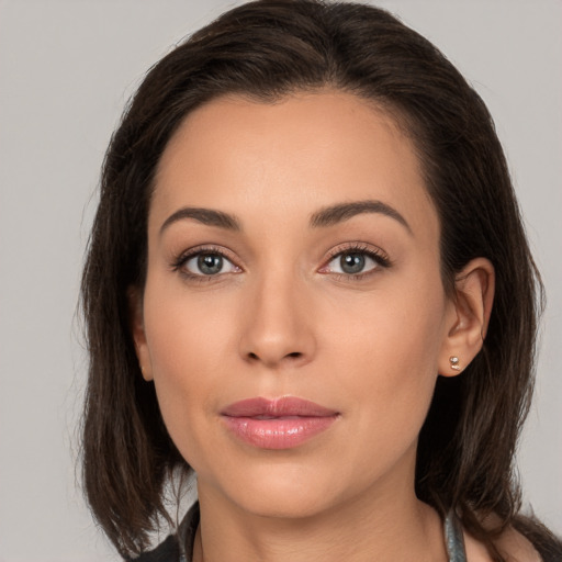 Joyful white young-adult female with medium  brown hair and brown eyes