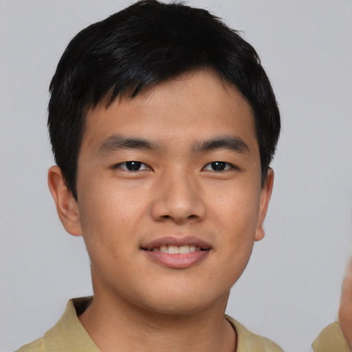Joyful asian young-adult male with short  brown hair and brown eyes