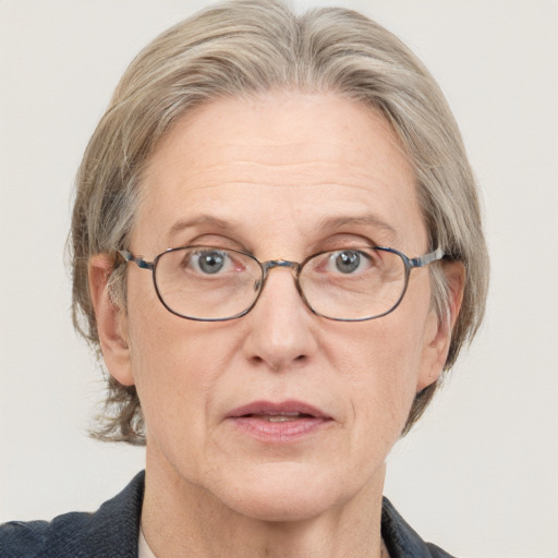 Joyful white middle-aged female with medium  brown hair and blue eyes