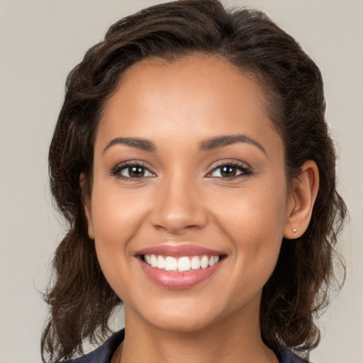 Joyful white young-adult female with long  brown hair and brown eyes