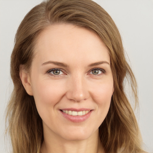 Joyful white young-adult female with long  brown hair and blue eyes