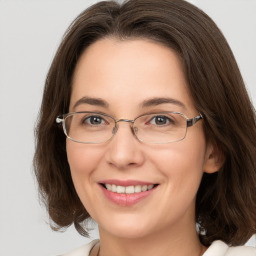 Joyful white young-adult female with medium  brown hair and grey eyes