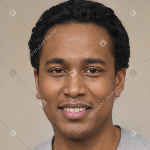 Joyful black young-adult male with short  black hair and brown eyes