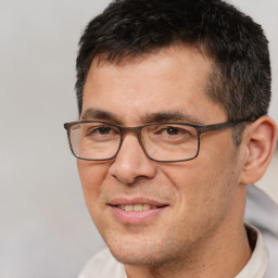 Joyful white adult male with short  brown hair and brown eyes