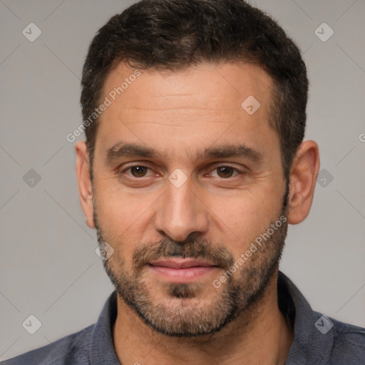 Joyful white adult male with short  brown hair and brown eyes