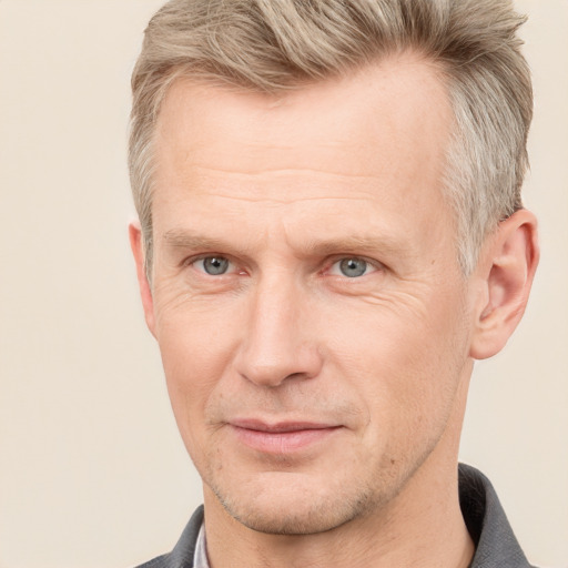 Joyful white adult male with short  brown hair and grey eyes