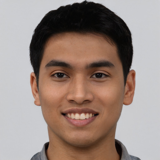 Joyful asian young-adult male with short  black hair and brown eyes