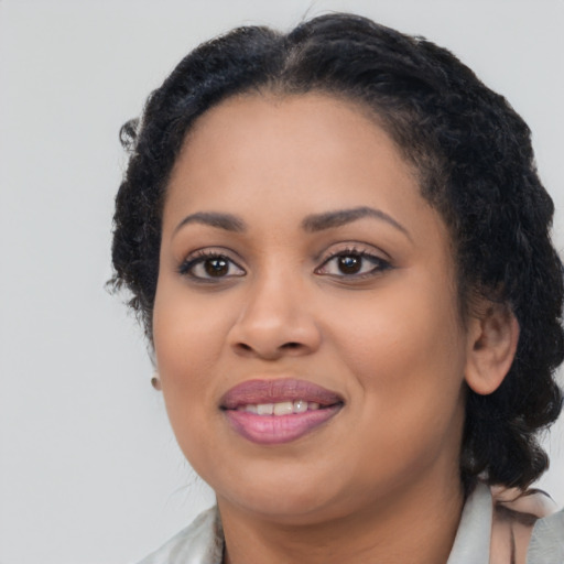 Joyful black young-adult female with medium  brown hair and brown eyes
