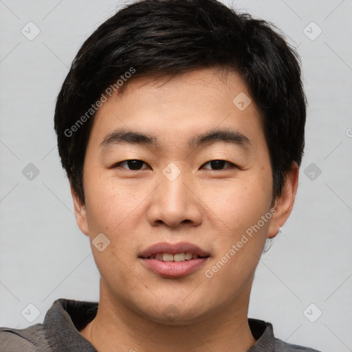 Joyful asian young-adult male with short  brown hair and brown eyes