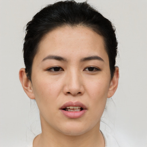 Joyful asian young-adult female with short  brown hair and brown eyes
