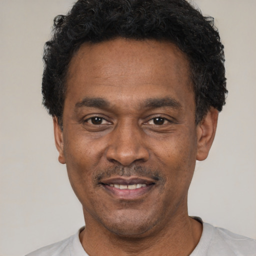Joyful latino adult male with short  black hair and brown eyes
