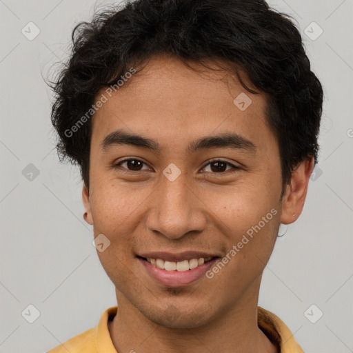 Joyful latino young-adult male with short  brown hair and brown eyes