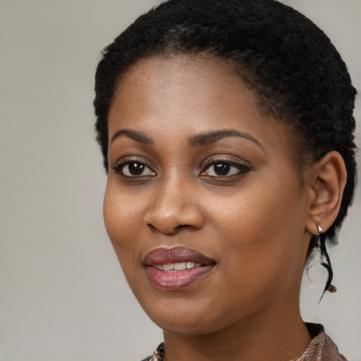 Joyful black young-adult female with medium  black hair and brown eyes