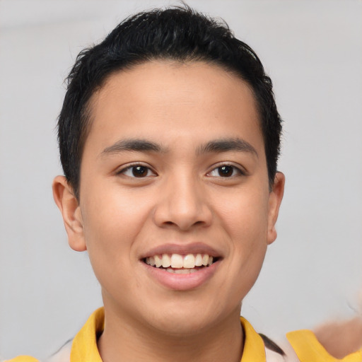 Joyful latino young-adult male with short  brown hair and brown eyes