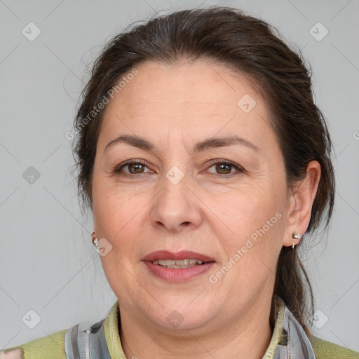 Joyful white adult female with medium  brown hair and brown eyes