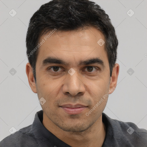 Joyful asian adult male with short  black hair and brown eyes