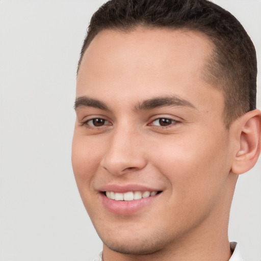 Joyful white young-adult male with short  brown hair and brown eyes