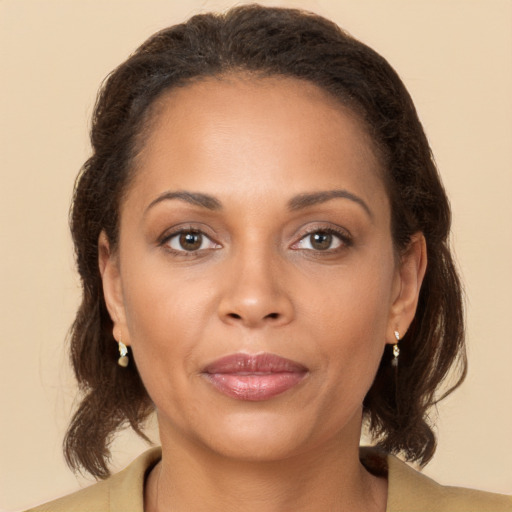 Joyful latino young-adult female with medium  brown hair and brown eyes