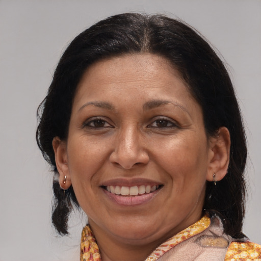 Joyful latino adult female with medium  brown hair and brown eyes
