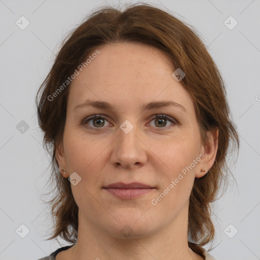 Joyful white adult female with medium  brown hair and grey eyes