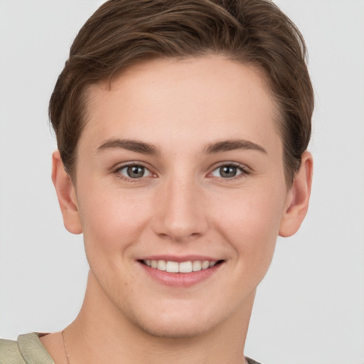 Joyful white young-adult female with short  brown hair and grey eyes