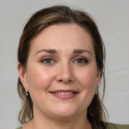 Joyful white adult female with medium  brown hair and grey eyes