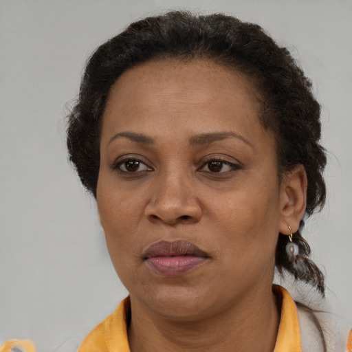 Joyful black adult female with short  brown hair and brown eyes