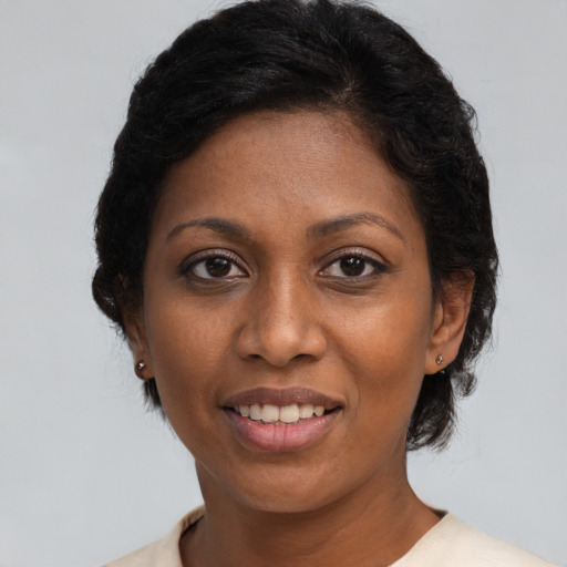 Joyful black young-adult female with medium  brown hair and brown eyes