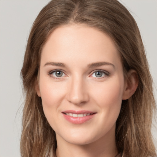 Joyful white young-adult female with long  brown hair and grey eyes