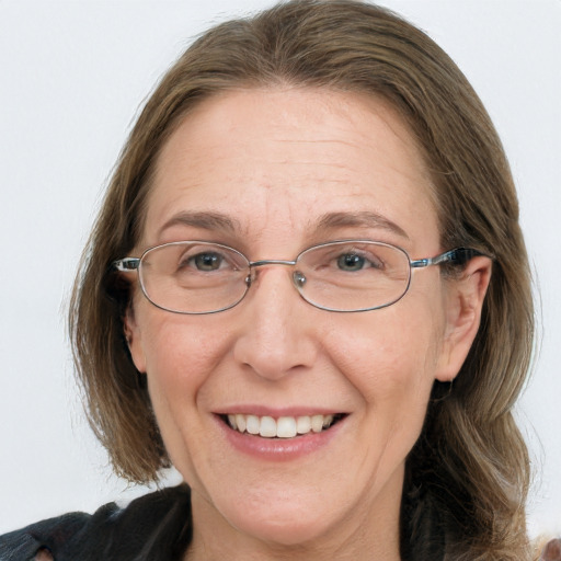 Joyful white middle-aged female with medium  brown hair and blue eyes