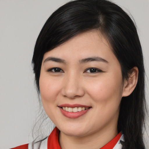 Joyful white young-adult female with medium  black hair and brown eyes