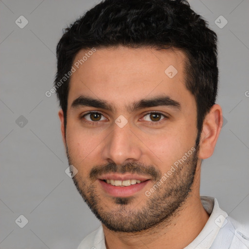 Joyful white young-adult male with short  black hair and brown eyes