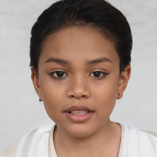 Joyful latino child female with short  brown hair and brown eyes