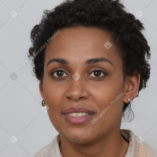 Joyful black young-adult female with short  brown hair and brown eyes