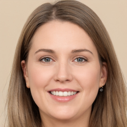 Joyful white young-adult female with long  brown hair and grey eyes