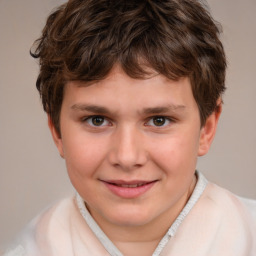 Joyful white child male with short  brown hair and brown eyes